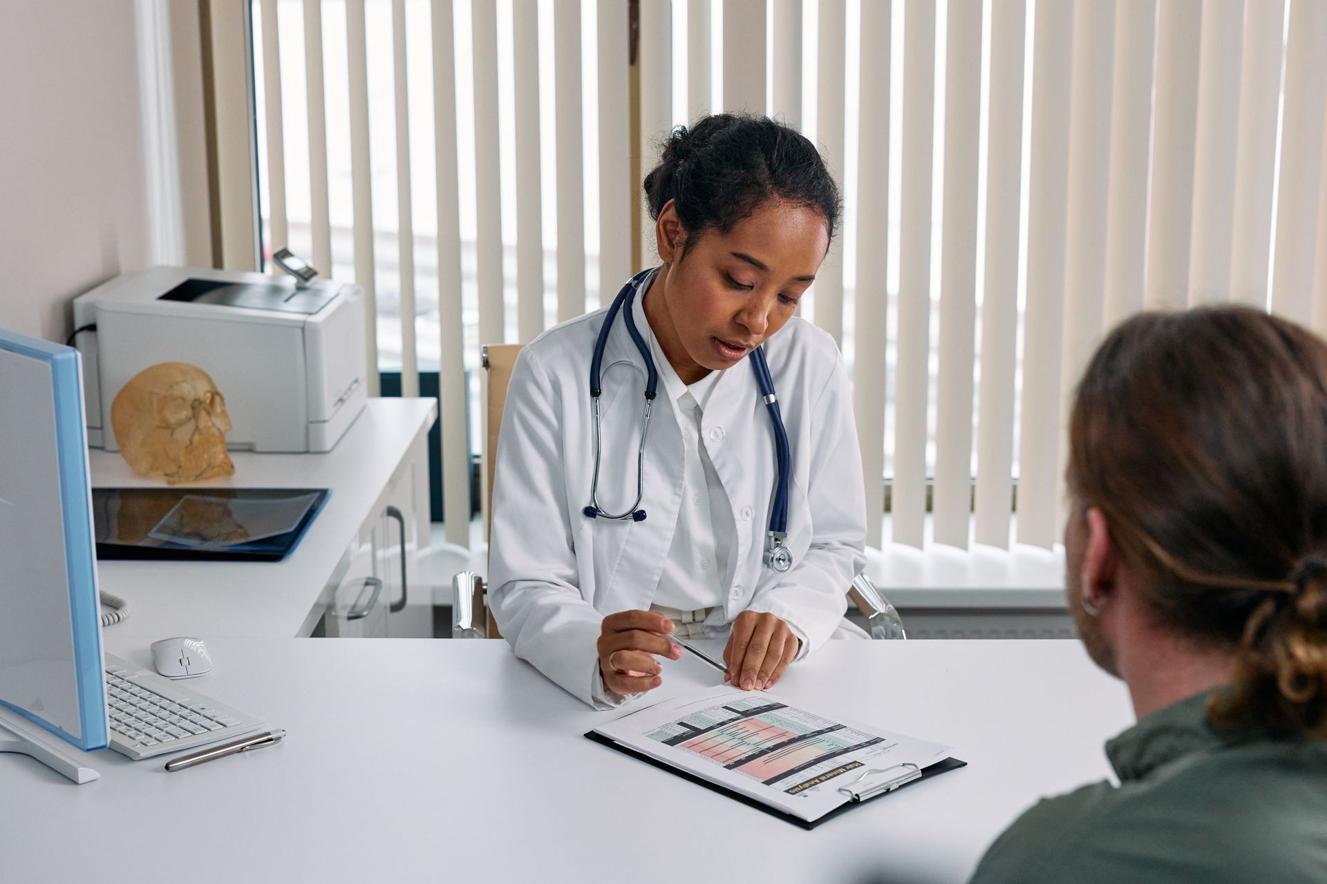 A doctor reviews medical information with a patient during a consultation