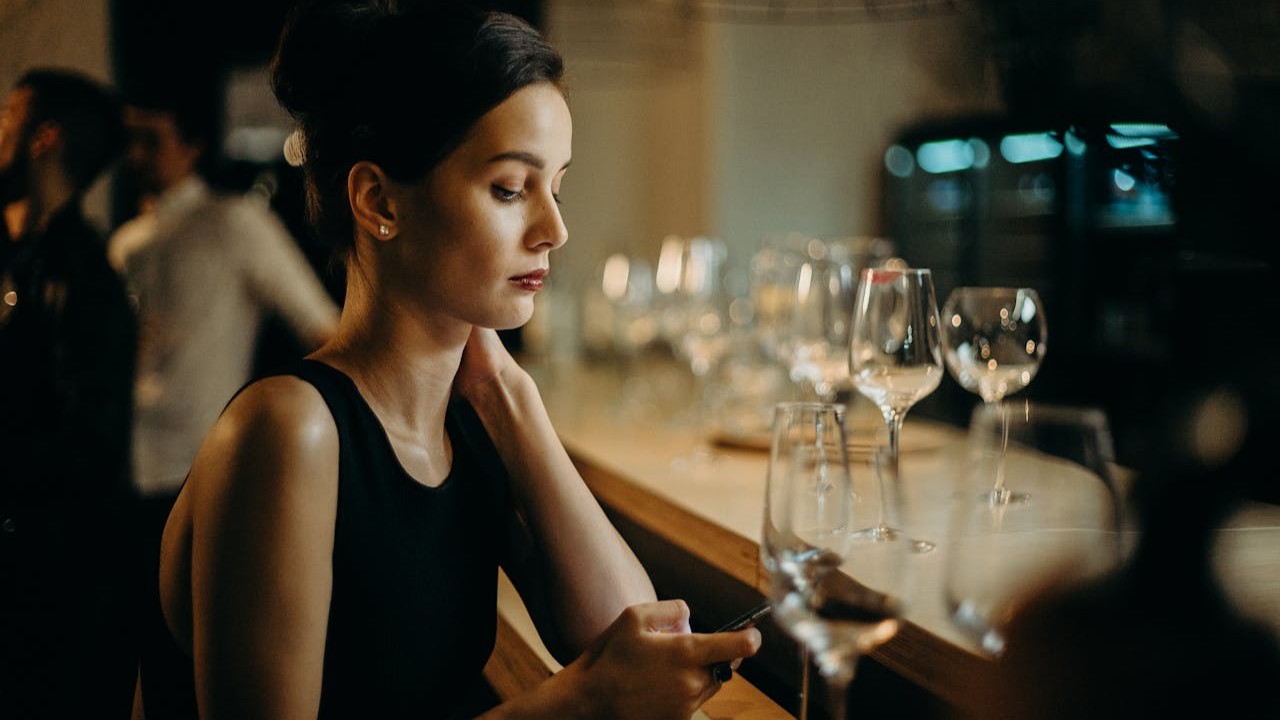 Single woman sitting thoughtfully at a table planning to start a family