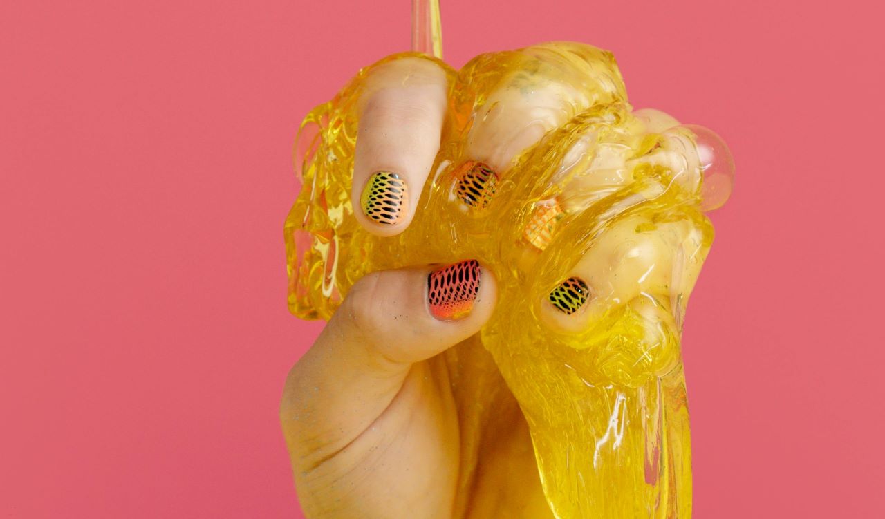 Close-up of transparent, stretchy cervical mucus on a clean finger